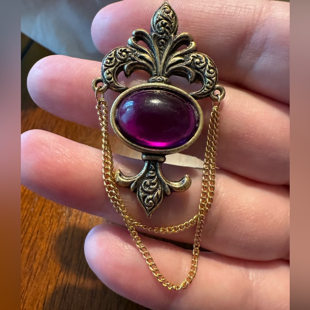 Begere brooch, antiqued gold toned purple cabachon, 2 gold toned dangle chains.